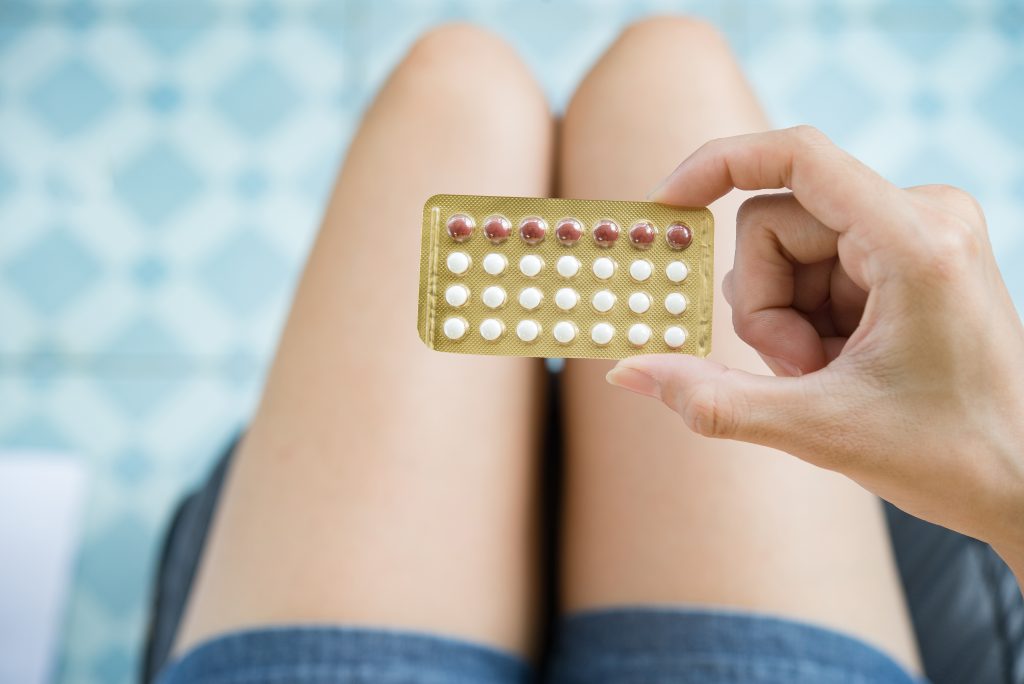 woman holding contraception progestin and oestrogen